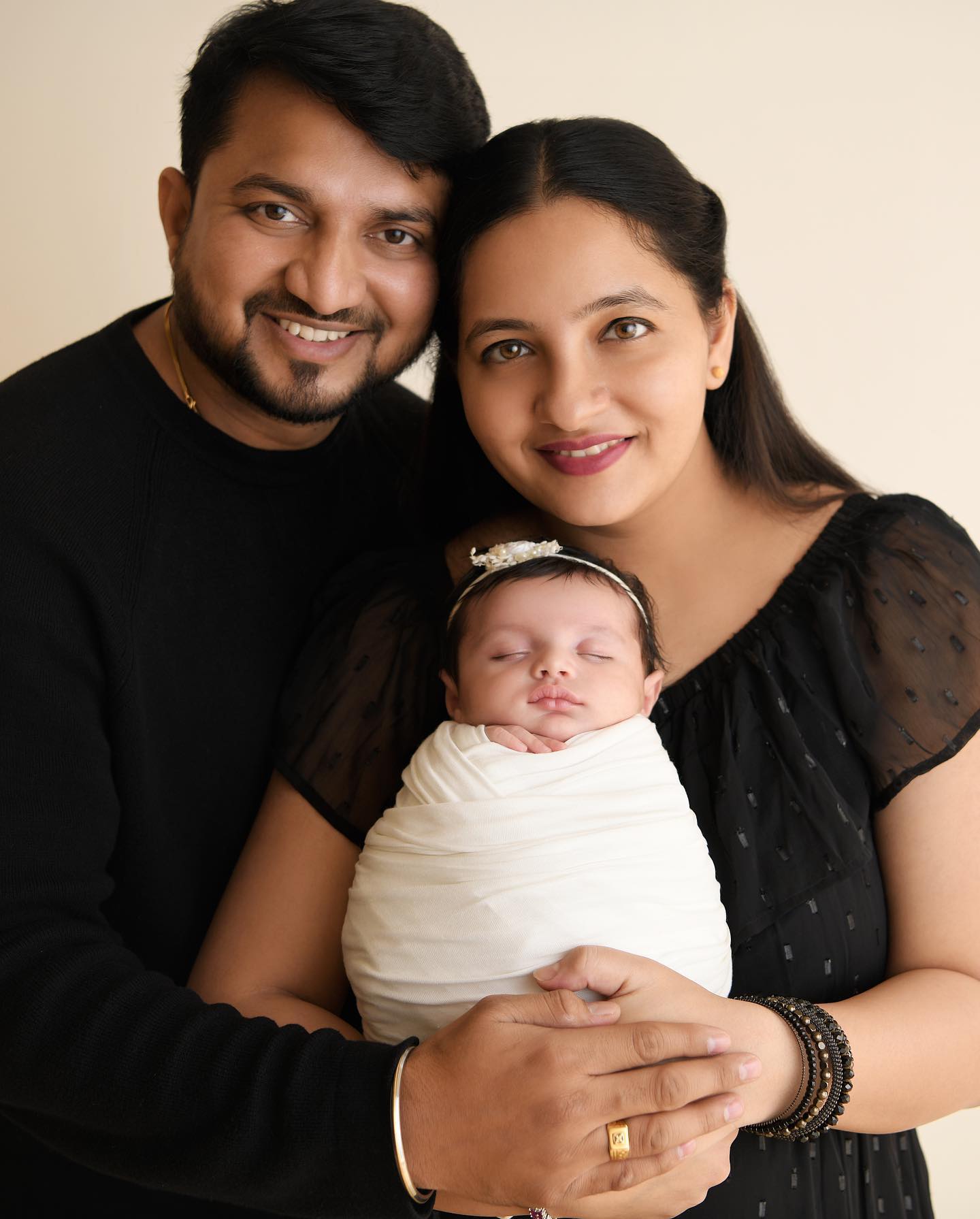Gentle baby and family moment captured in studio